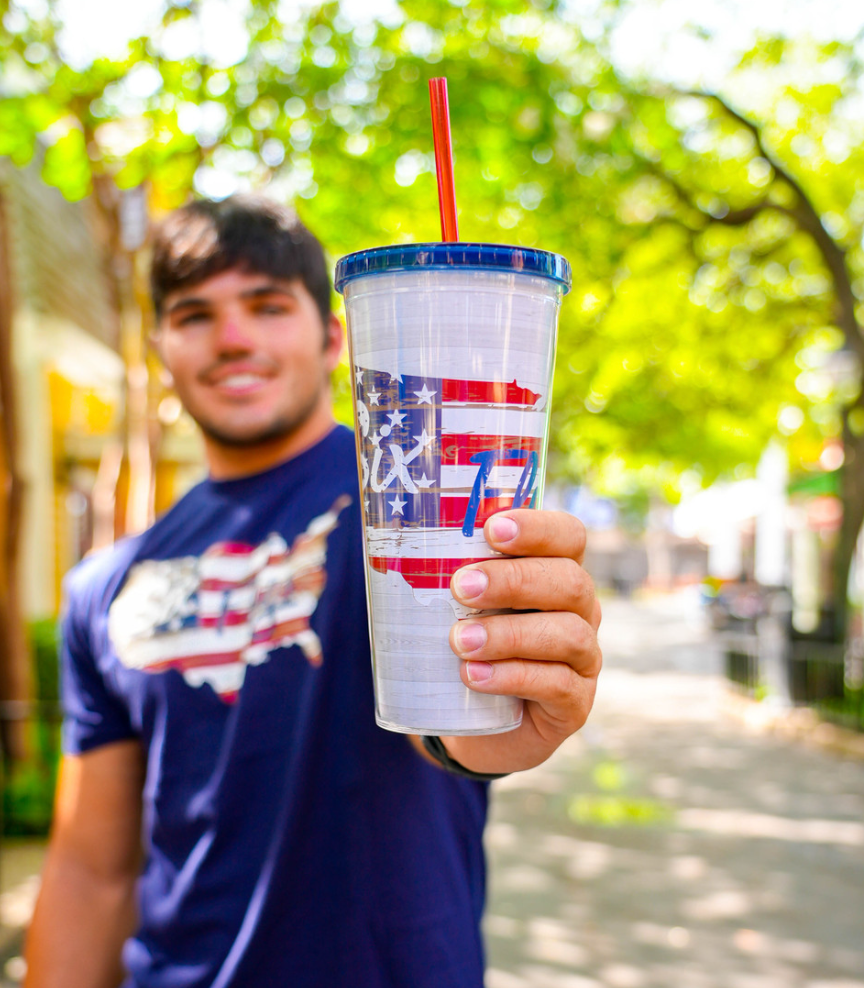 PERSON HOLDING SIX FLAGS AMERICANA TUMBLER